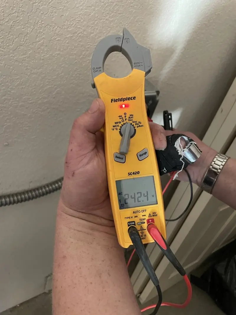 Voltage testing with clamp meter during Recessed Lighting Installation in Frederick